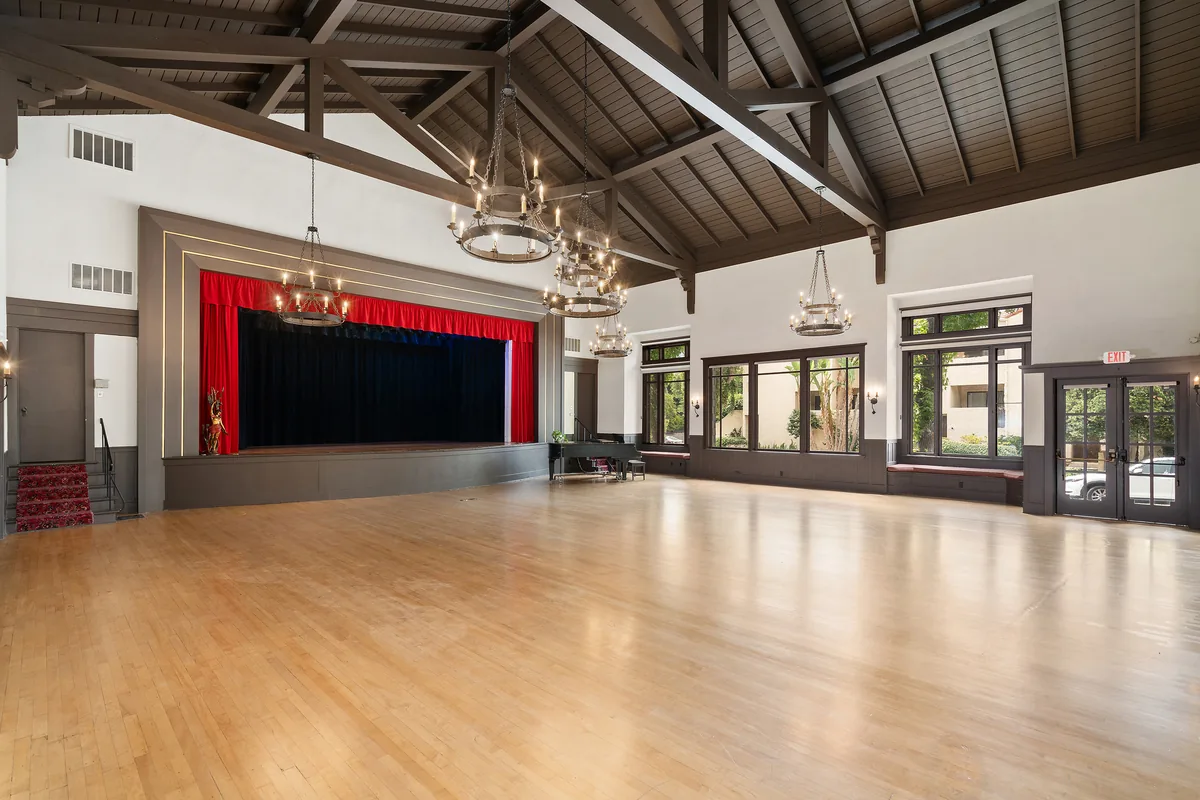 The Clubhouse hall and stage arranged for a concert or recital